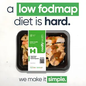 Flat-lay of a prepared chicken and vegetable meal with the two-tone headline 'a low fodmap diet is hard' and 'we make it simple'