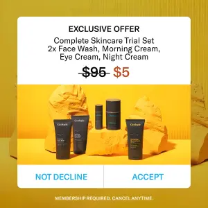 Dark skincare bottles on bright yellow rocks under a white system-alert pop-up showing a crossed-out $95 price next to $5