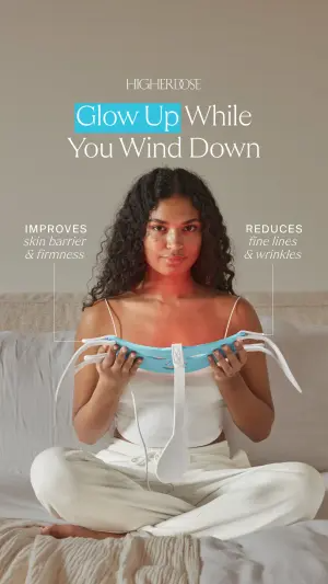Lifestyle ad of a woman holding a red light therapy mask with two thin pointer lines naming skin benefits